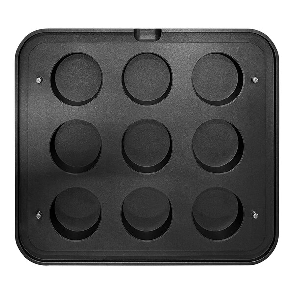 A black Pavoni round insert plate with 9 cavities.