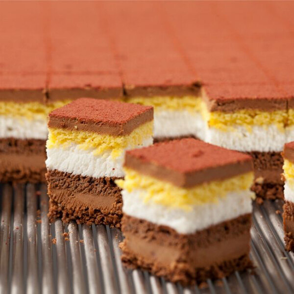 A metal tray with brown and yellow squares of chocolate.