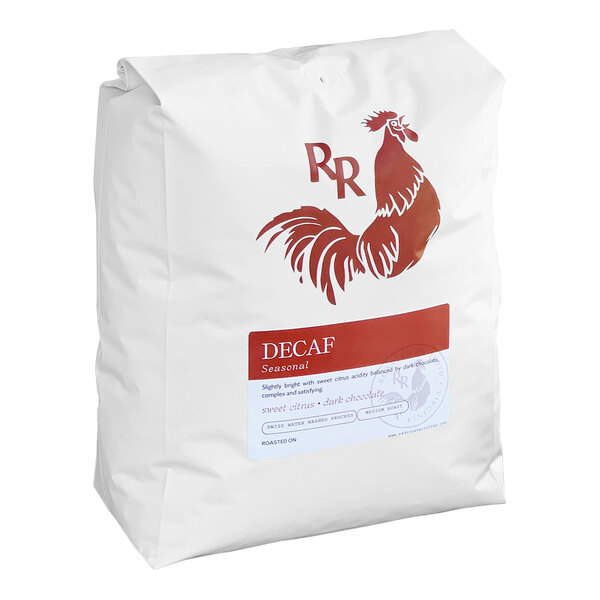 A white bag with a red logo for Red Rooster Organic Decaf Peru Whole Bean Coffee with a red rooster on it.
