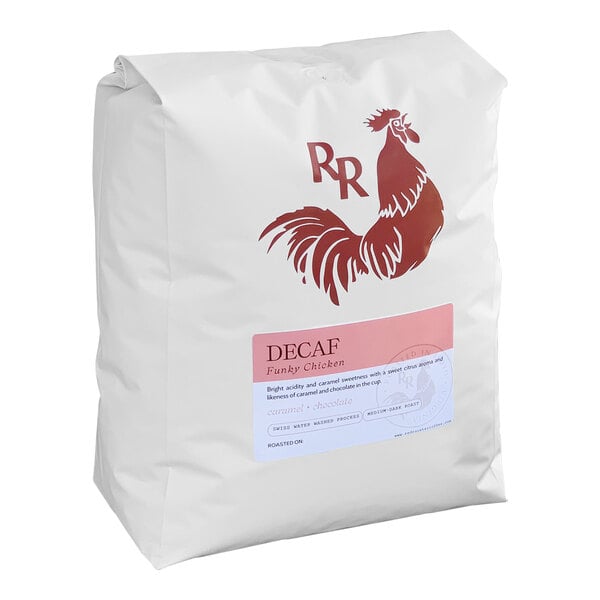 A white bag of Red Rooster Organic Decaf Funky Chicken whole bean coffee with a red and white label with a rooster.
