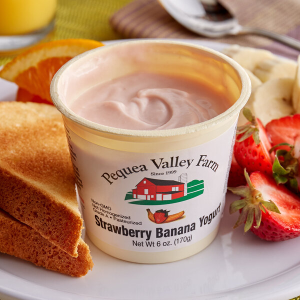 A cup of Pequea Valley Farm strawberry banana yogurt with fruit.