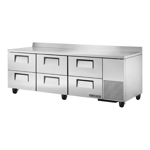 A stainless steel True worktop refrigerator with six drawers.