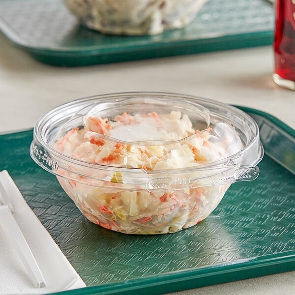 A tray with a plastic Inline Plastics Safe-T-Fresh bowl of coleslaw.