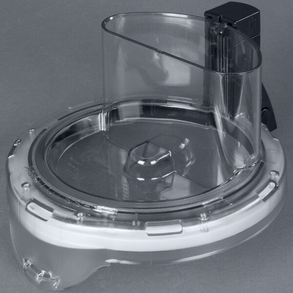 A clear plastic container with a black lid for a Waring commercial food processor.