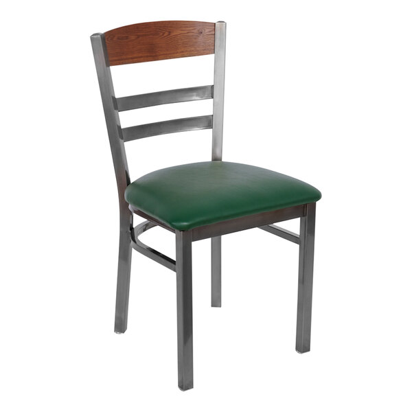 A BFM Seating metal side chair with a green vinyl seat and a wood back panel.
