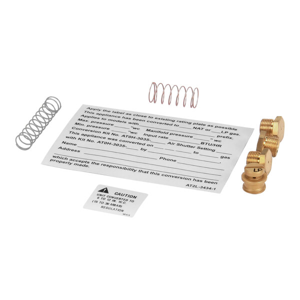 A paper with brass screws and a spring for an AccuTemp G1 Series griddle conversion kit.