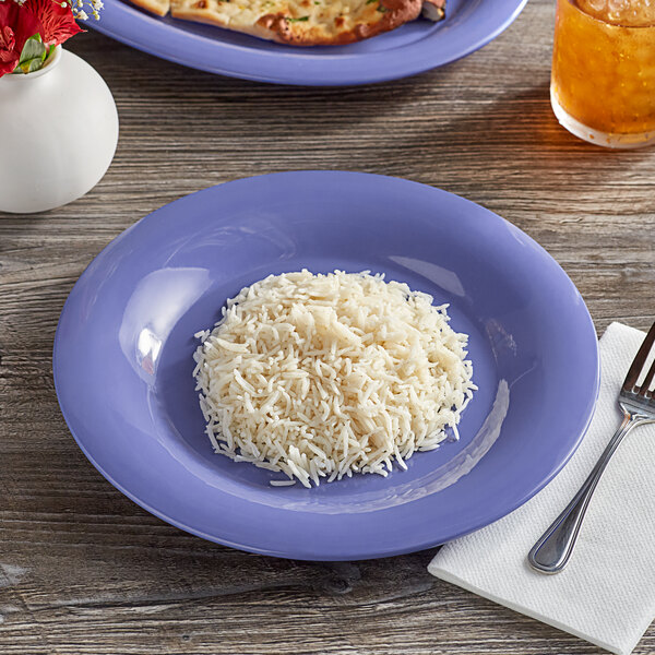 A purple Acopa Foundations melamine plate with rice and a fork on a table.