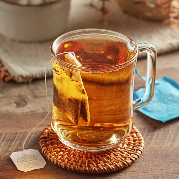 A glass mug of Harney & Sons Organic Earl Grey Tea with a tea bag in it.