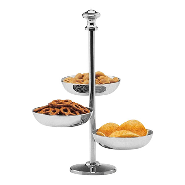 A Hepp by Bauscher stainless steel 3-tiered snack stand with a variety of snacks in bowls.