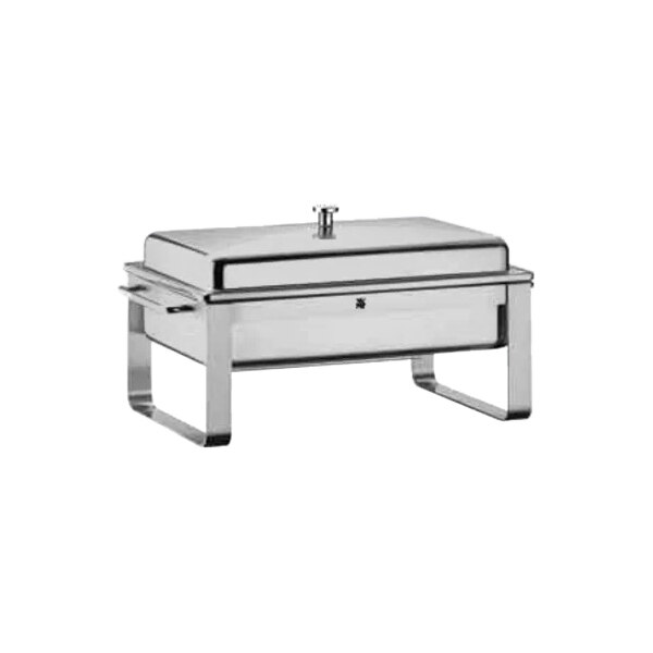 A WMF stainless steel rectangular chafer with a lid and porcelain inserts on a counter.
