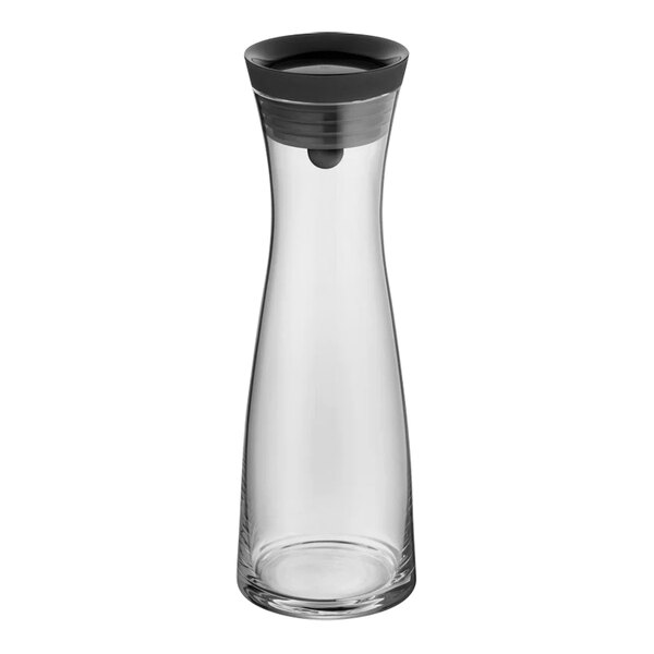 A clear glass carafe with a black lid.
