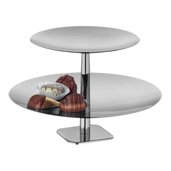 A silver stainless steel 2-tier pastry stand holding a tray of chocolates.