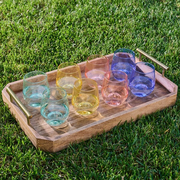 A tray of Tossware Royal Blue Vino glasses on a table.