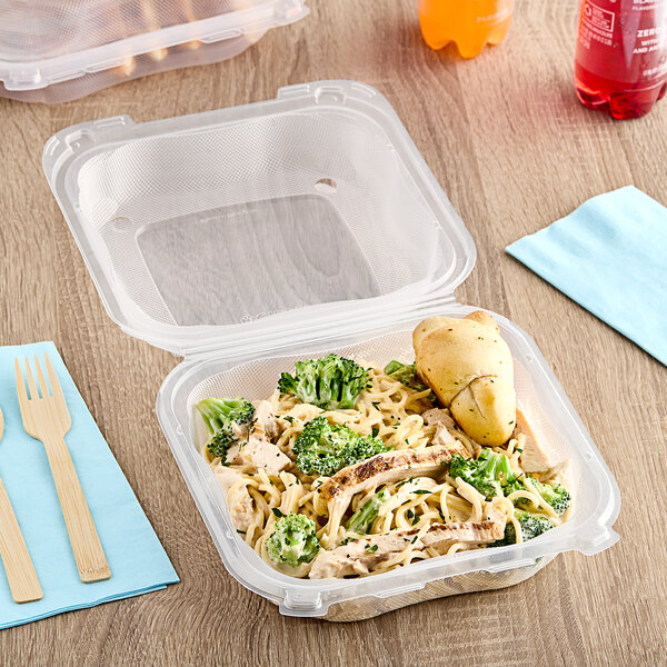 A Genpak clear plastic hinged container with food inside.