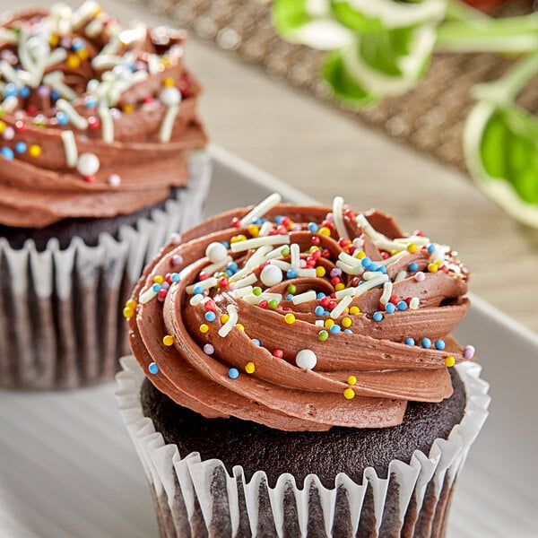 A chocolate cupcake with Supernatural Rainbow sprinkles on top.