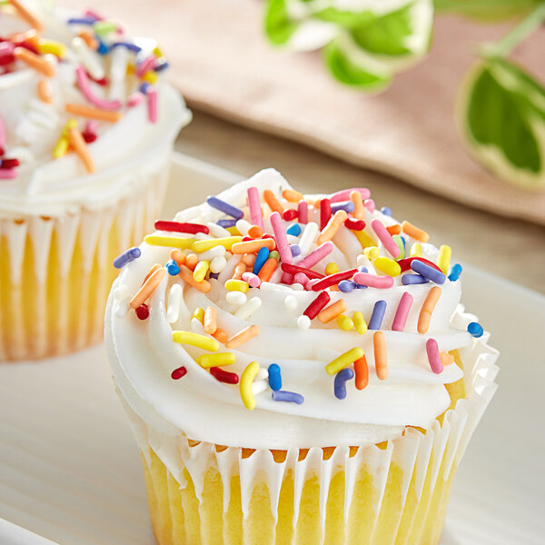 A cupcake with frosting and Supernatural Rainbow Softies sprinkles on top.