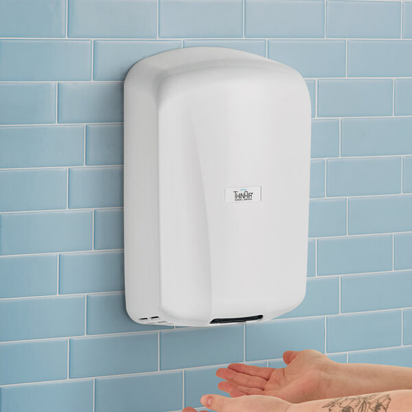 A woman's hand drying under a white Excel ThinAir hand dryer.
