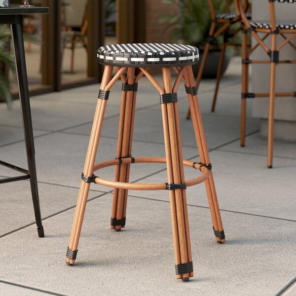 Lancaster Table & Seating Bistro Series Black and White Checkered Weave Rattan Outdoor Backless Barstool