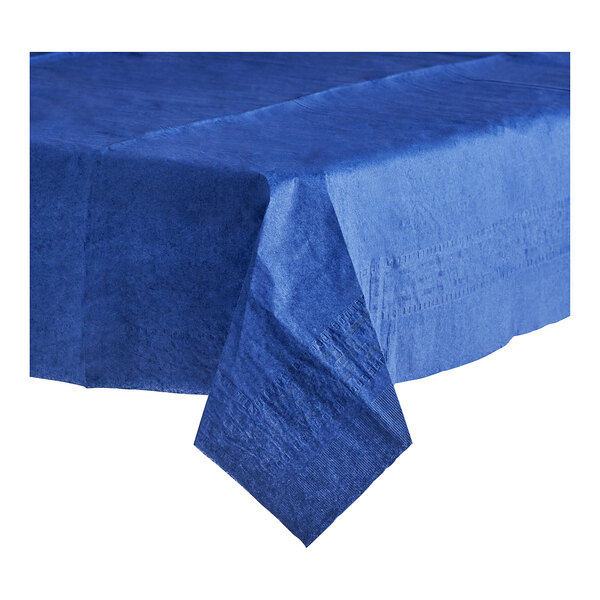 A folded navy blue Table Mate tablecloth on a table.