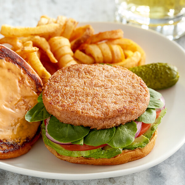 A plate of food with a Plant-Based Salmonish Burger and fries.
