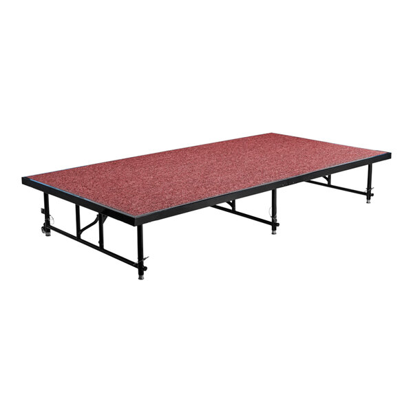 A red rectangular National Public Seating stage platform with black metal legs.