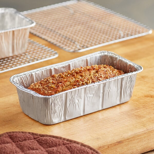 A loaf of bread in a Baker's Lane aluminum foil tin pan.