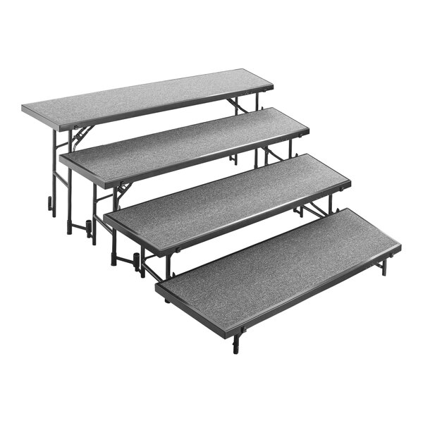 A rectangular gray National Public Seating choral riser with four black metal steps.