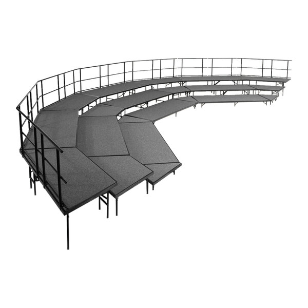A black stage with metal railings.