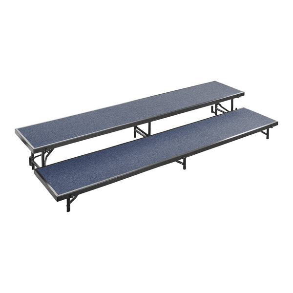 Two blue National Public Seating 2-level carpeted stage risers with black bases.
