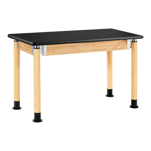 A black rectangular National Public Seating science lab table with oak legs.