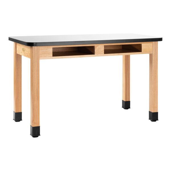 A wood National Public Seating science lab table with built-in book compartments.