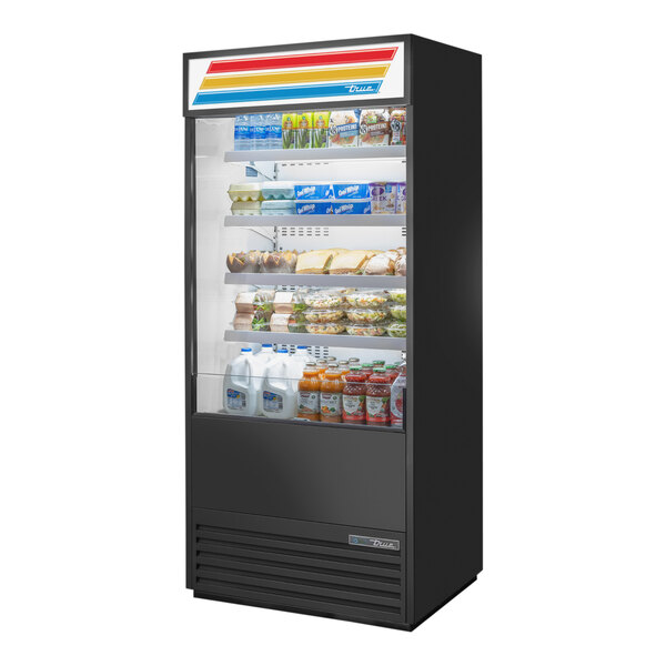 A True refrigerated air curtain merchandiser with food on shelves in a convenience store.