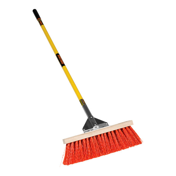 A Structron Street / Landscape push broom with a yellow handle.