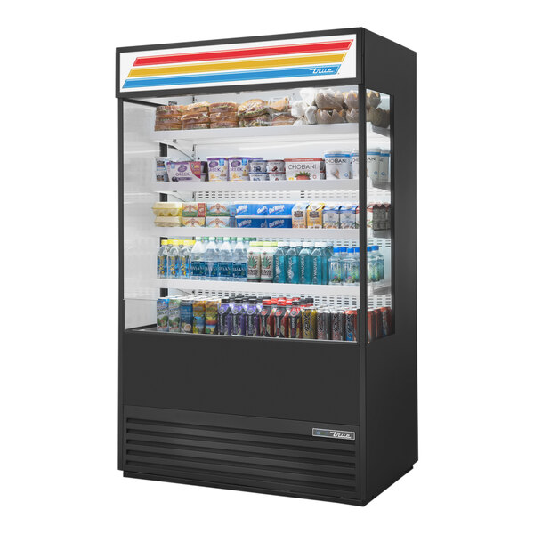 A True refrigerated air curtain merchandiser with glass sides filled with drinks and snacks.