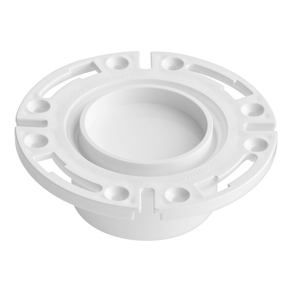 A white plastic Sioux Chief water closet flange with holes in a white circle.
