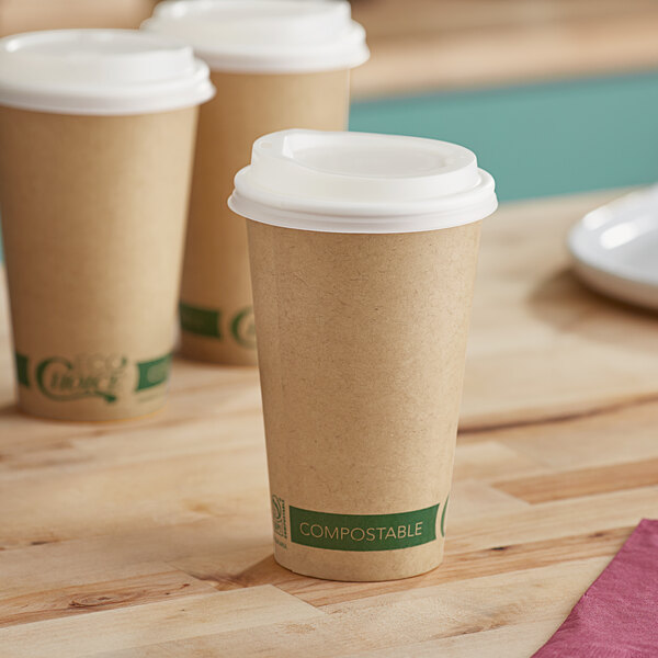 Three EcoChoice Kraft paper cups with PLA lids on a table.