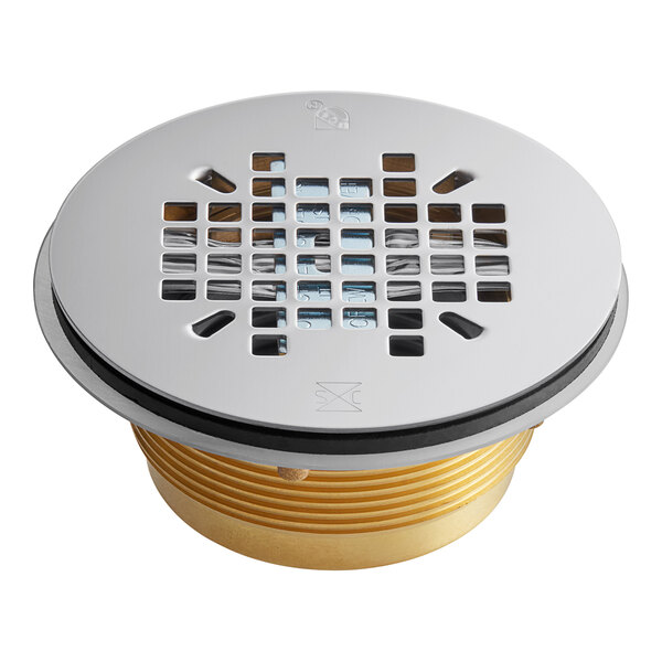 A close up of a Sioux Chief brass shower module drain with a stainless steel strainer.