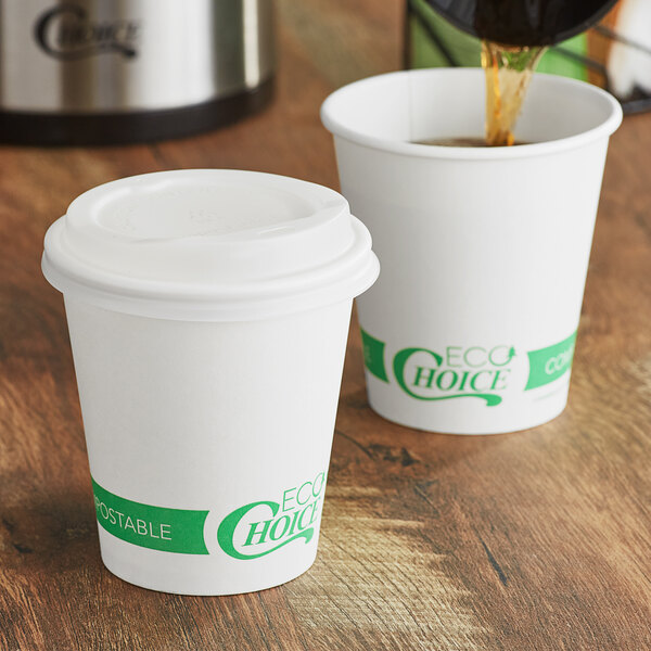 Two EcoChoice white compostable paper hot cups with lids being filled with coffee.
