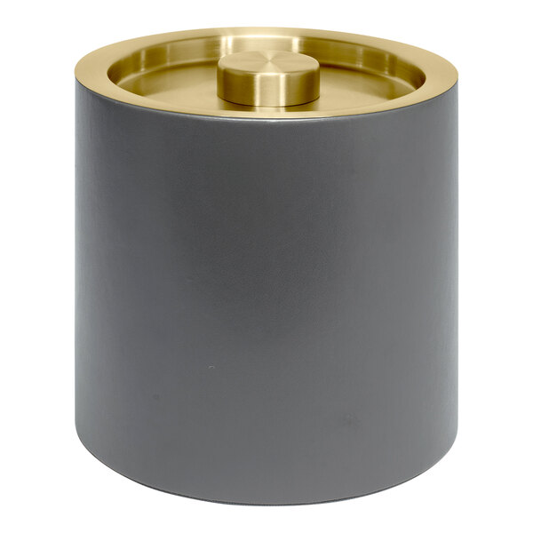 A round grey metal Room360 London ice bucket with a matte brass lid.