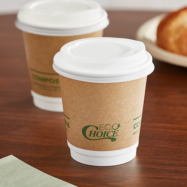 Two EcoChoice Kraft paper hot cups with lids on a table.