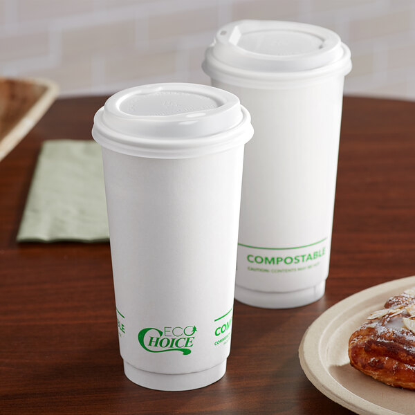 Two EcoChoice white paper cups with coffee on a table.