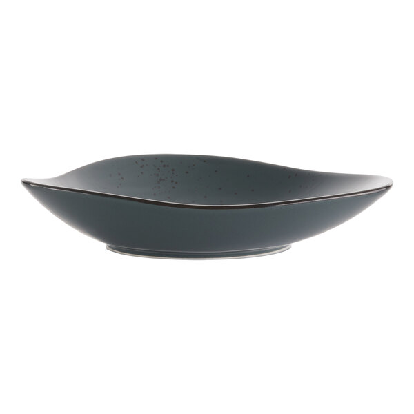 A close up of a dark gray International Tableware Lunar Blue stoneware bowl with a speckled design and black rim.