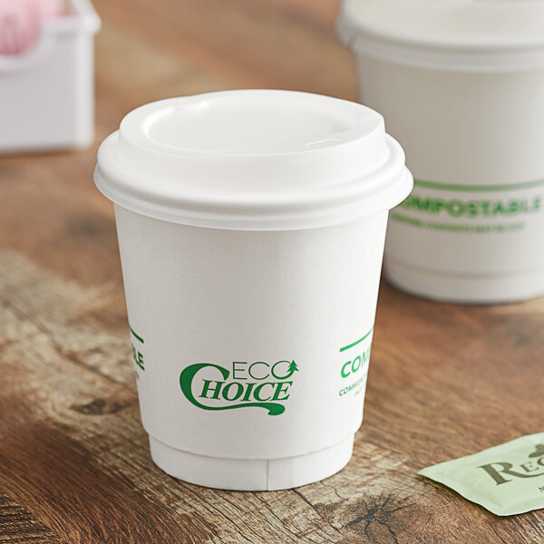 A white EcoChoice compostable paper hot cup with a lid.
