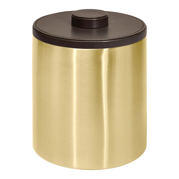 A gold metal Room360 London ice bucket with a brown lid on a table.