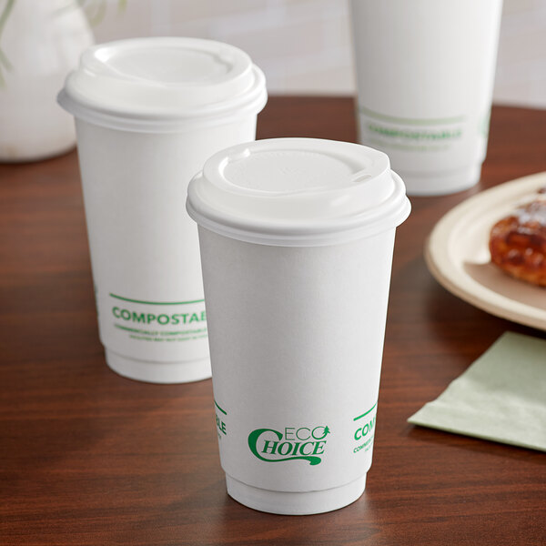 A group of EcoChoice white paper hot cups with lids on a table.