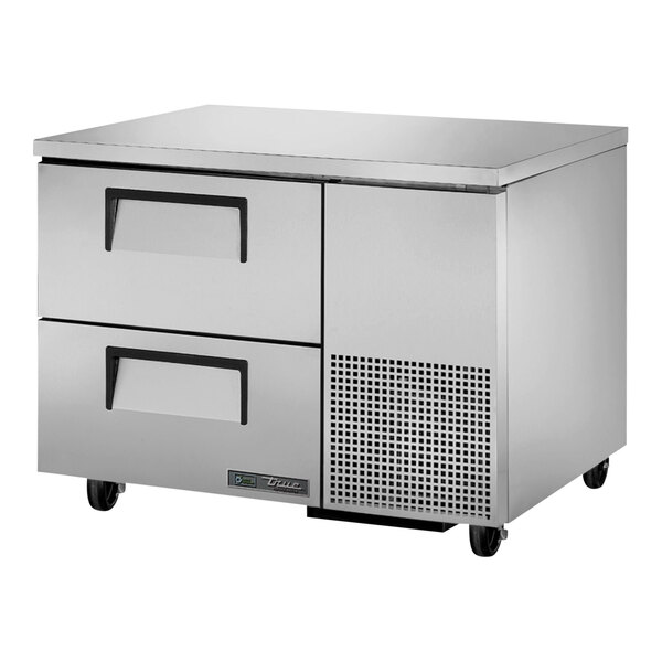 A silver True undercounter refrigerator with two drawers.