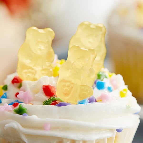 A cupcake with Albanese Pineapple Gummi Bears on top.