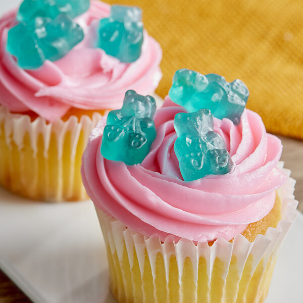 A cupcake with blue frosting and Albanese Light Blue Watermelon Gummi Bears on top.