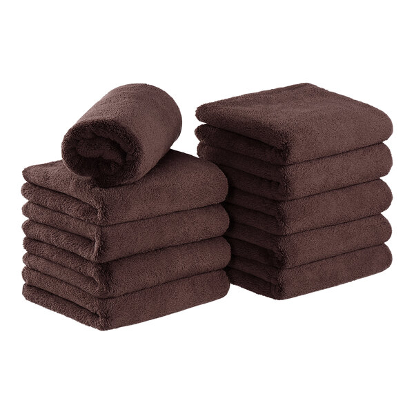 A stack of brown Monarch Brands coral fleece hand towels.