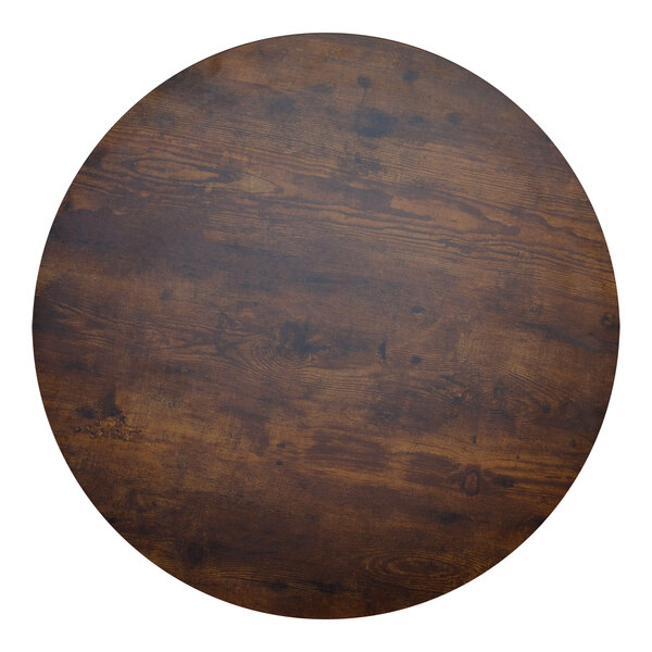 A BFM Seating Relic vintage walnut round table top with a matching edge.